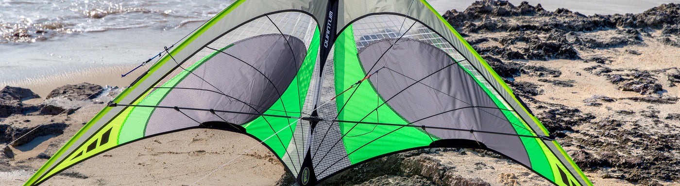 Closeup shot of a Graphite colored Quantum sport kite on the beach