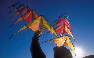 Two stacks of micron stunt kites being held in the air