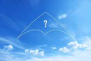 Dotted outline of a sport kite in the sky, with a question mark in the middle