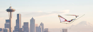Zero G glider flying in front of Seattle skyline