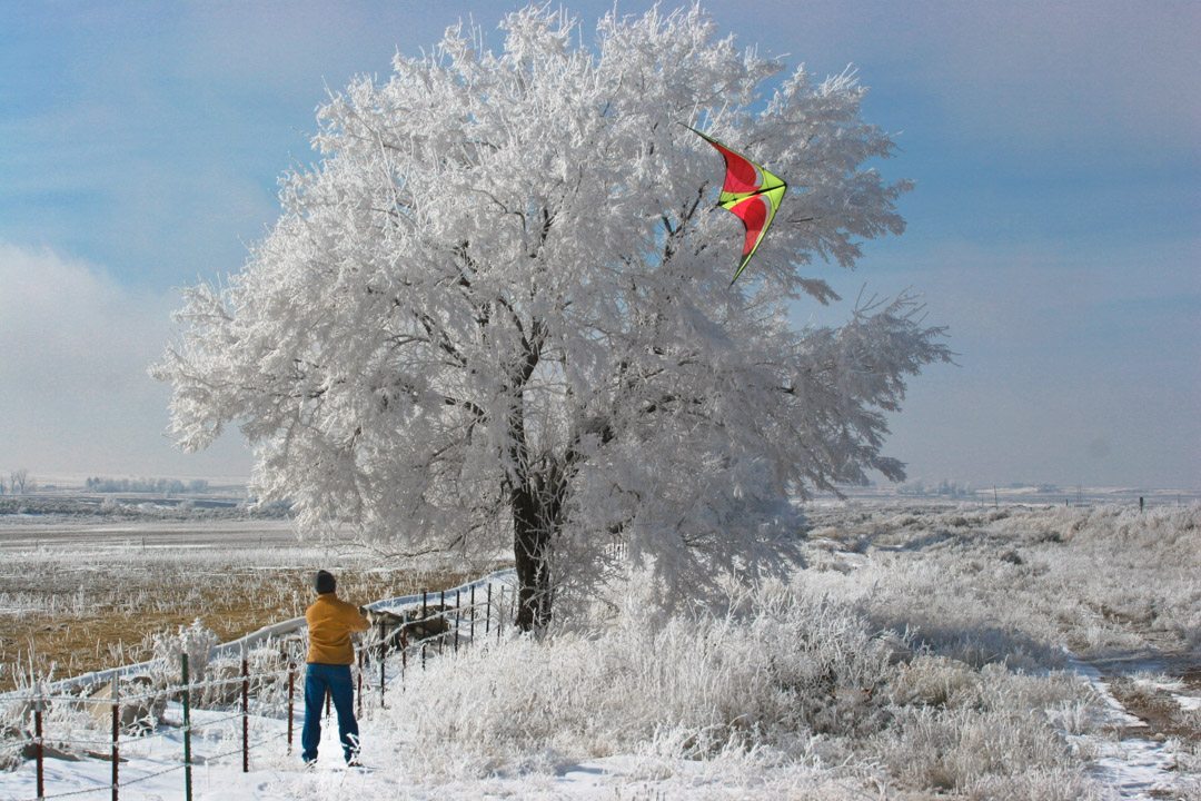 Mark flying a red Quantum stunt kite in the snow