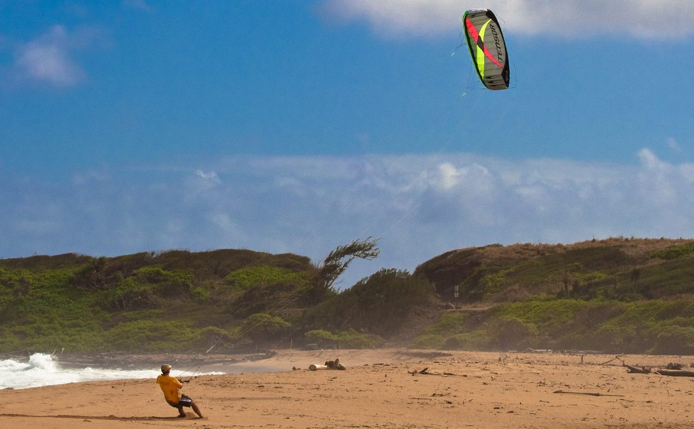Man flying Tensor on the beach